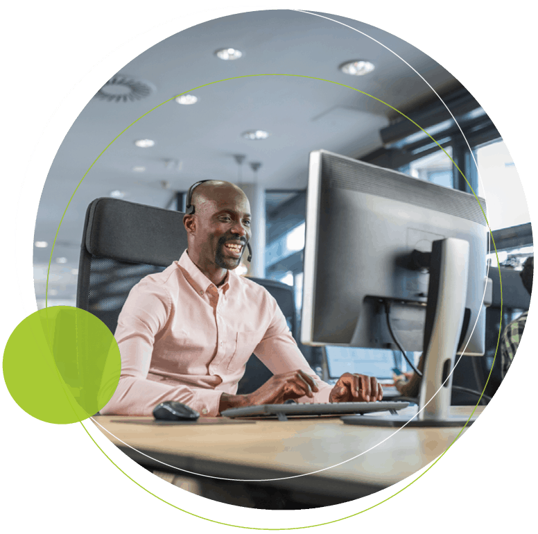 man smiling working at a desk)